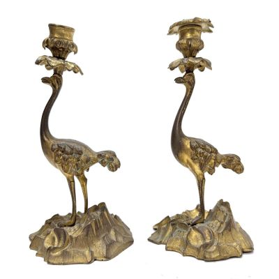 pair of brass candlesticks with birds on top of a rock