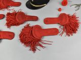 many pairs of red shoes and a hat on a table