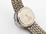 an image of a close up of a wrist watch on a white surface