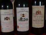 several bottles of wine are lined up on a red table