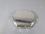an image of a small silver plate on a white surface