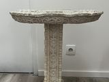 a white table with a birdbath on top of it