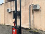 a picture of a forklift parked in front of a building