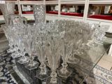 a lot of wine glasses sitting on a glass table
