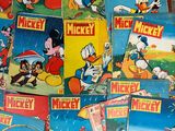 a lot of mickey mouse comics on the table