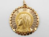Gros plan sur une médaille d'or portant le visage d'une femme