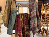 a rack with several scarves on it in a store