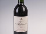 bottle of red wine with a red cap on a white background
