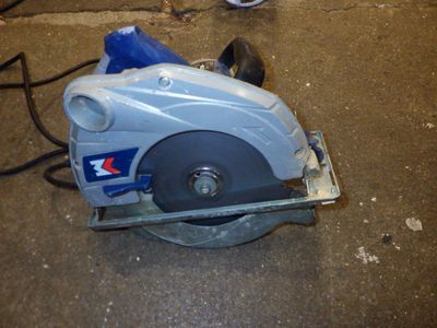 someone is using a circular saw to cut a piece of wood