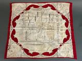 an image of a red and white quilt with a picture of a building