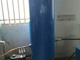 a blue tank sitting in a room next to a window