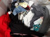 a pile of clothes that is sitting in a box
