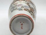 a white vase with a design on it on a white surface