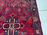 a red rug with a cross on it on a tile floor