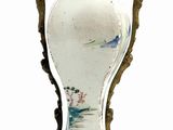 a vase that is sitting on a stand on a white surface