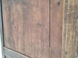 a close up of a wooden door with holes in it