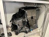 a bag that is hanging on a rack in a closet