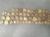 a close up of a pile of gold coins on a table