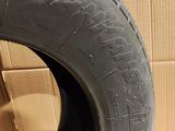 a close up of a tire on a cardboard box with a cardboard box in the background