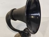 an old fashioned black and gold gramphone on a white surface