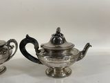 pair of silver plated teapots and saucers