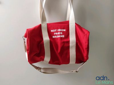 a red and white bag hanging on a wall