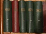 several books are lined up in a row on a shelf