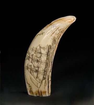 two pieces of ivory with a drawing of a boat on it