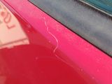 a red car with a sticker on the side of it