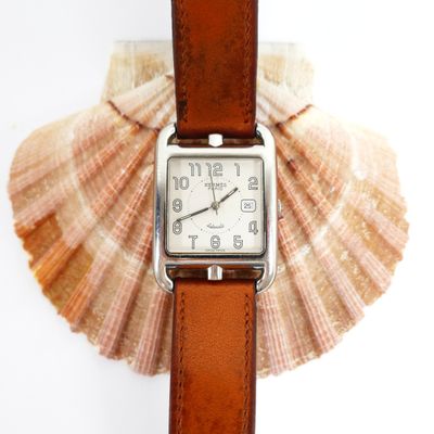 a watch that is sitting on top of a shell
