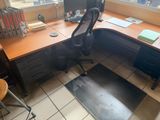 a desk with a chair and a computer on top of it