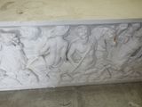 a white marble box with carvings on it in a room