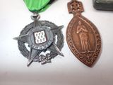 two medals on a table with a green ribbon