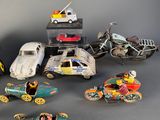 a lot of toy cars and motorcycles on the table