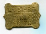 plaque en laiton sur laquelle figurent les mots « la bière » et un os de chien