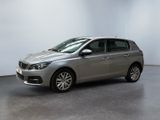 the silver car is parked in a large room with a white wall