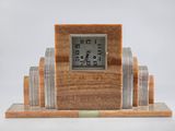 a clock that is sitting on top of a wooden stand