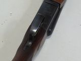 a rifle with a wooden handle on a table