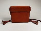 brown leather purse with tassels on a white background