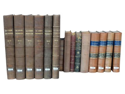several old books are stacked on top of each other on a white surface