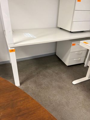 a white desk with a computer on it in a room