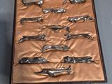 six pairs of scissors in a case on a table
