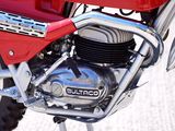 a close up of a red motorcycle parked on the side of the road