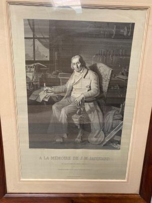an old picture of a man sitting in a chair in a room
