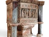 a very old looking stone shrine with statues on it