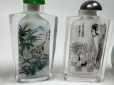 three glass vases with asian designs on them