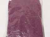 a purple towel in a plastic bag on a white surface