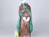 figurine représentant un homme barbu vêtu d'une cape verte