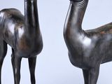 pair of bronze statues of a deer and a goat on a marble base