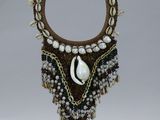 a picture of a necklace with a cowrie shell on it